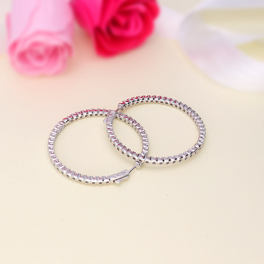 Flatlay view of CZ Large Inside-Out Hoop Earrings in Sterling Silver 1.9 inch