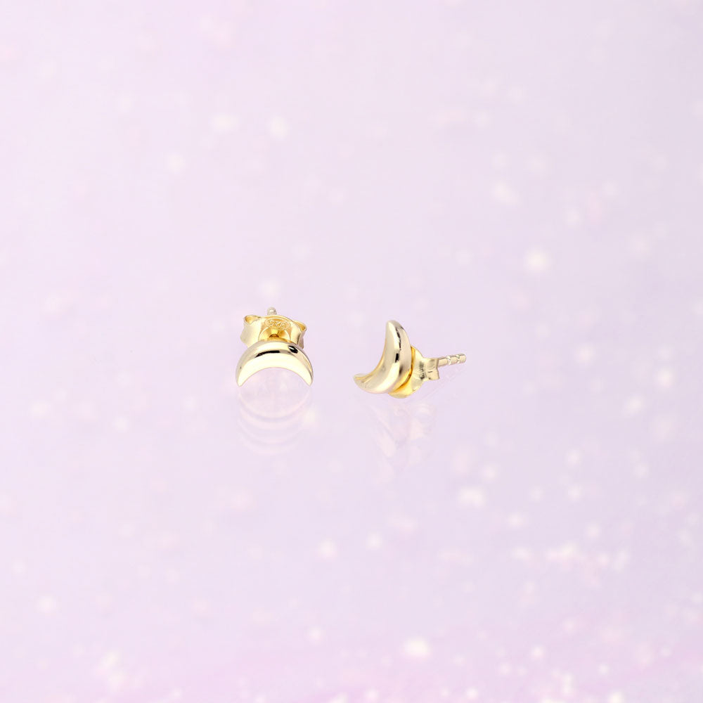 Flatlay view of Crescent Moon Cartilage Stud Earrings in Sterling Silver, Yellow Gold Flashed