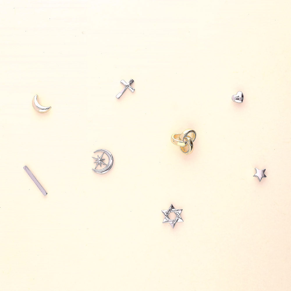 Flatlay view of Crescent Moon North Star Stud Earrings in Sterling Silver