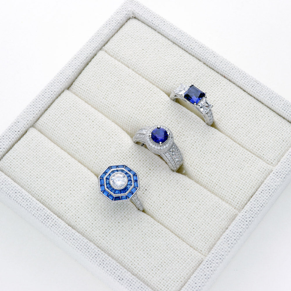 Flatlay view of Halo Milgrain Simulated Blue Sapphire Round CZ Ring in Sterling Silver