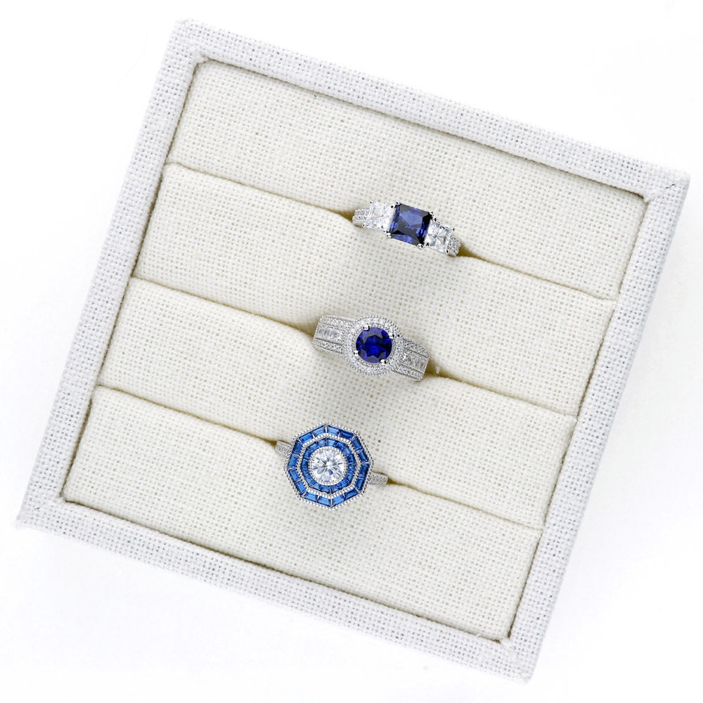 Flatlay view of 3-Stone Simulated Blue Sapphire Princess CZ Ring in Sterling Silver