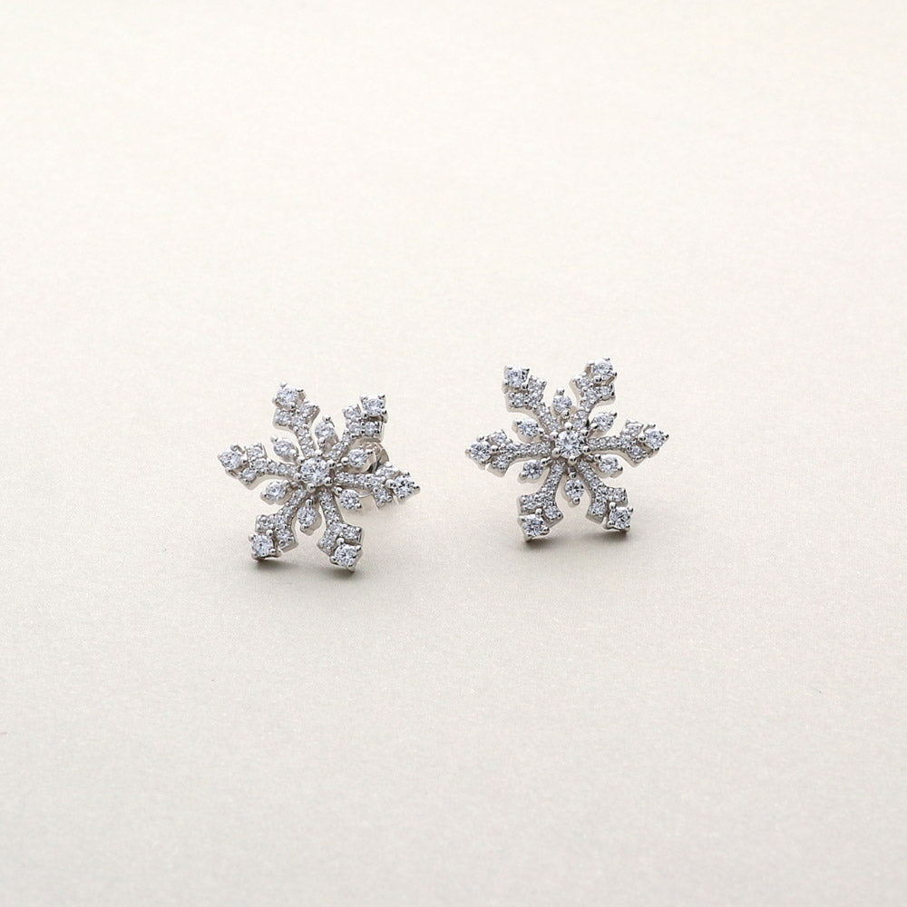 Flatlay view of Snowflake CZ Stud Earrings in Sterling Silver