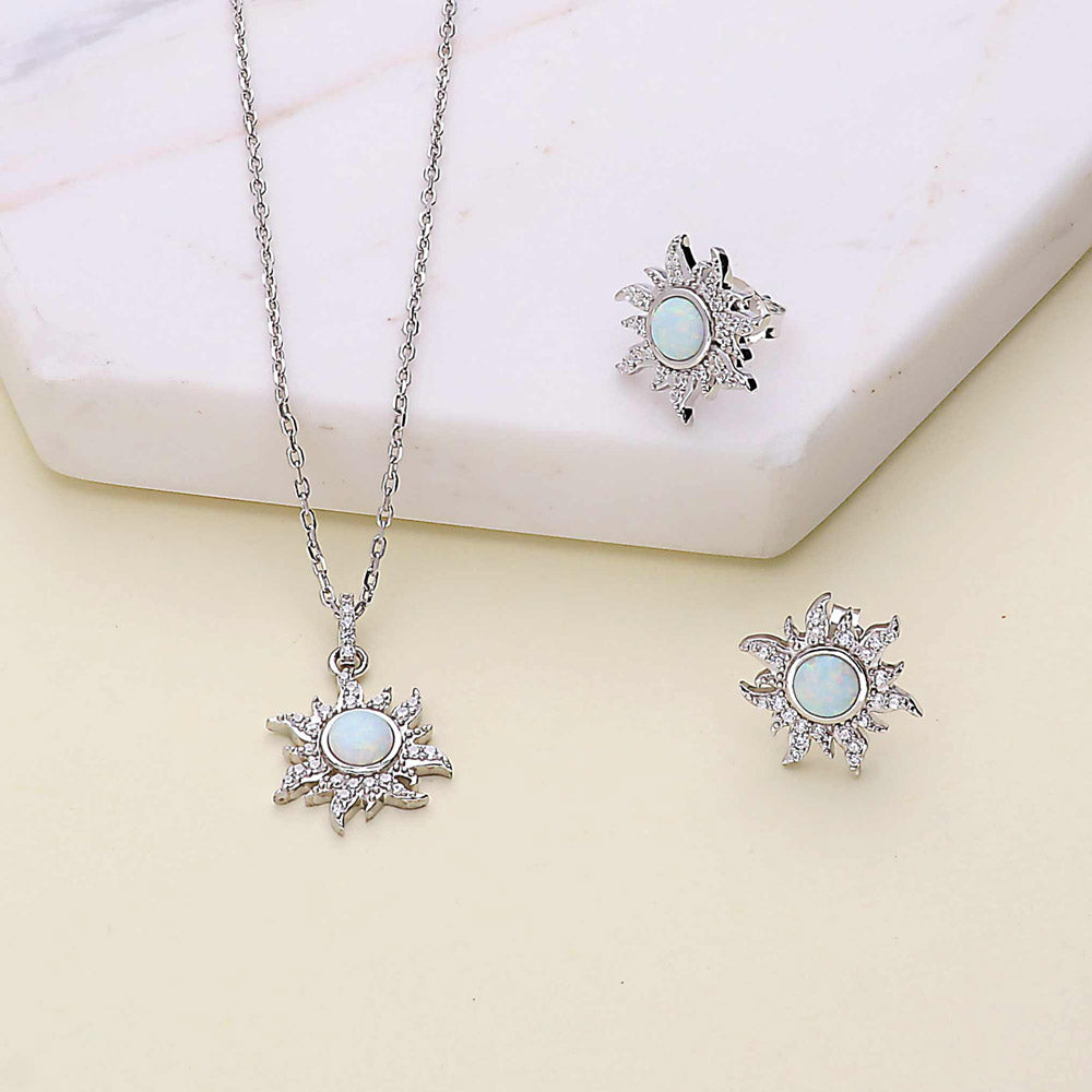 Flatlay view of Sunburst Halo Simulated Opal CZ Pendant Necklace in Sterling Silver, 9 of 11