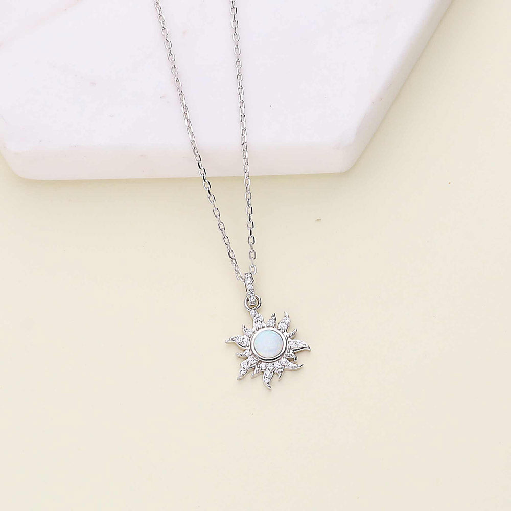 Flatlay view of Sunburst Halo Simulated Opal CZ Pendant Necklace in Sterling Silver, 7 of 11