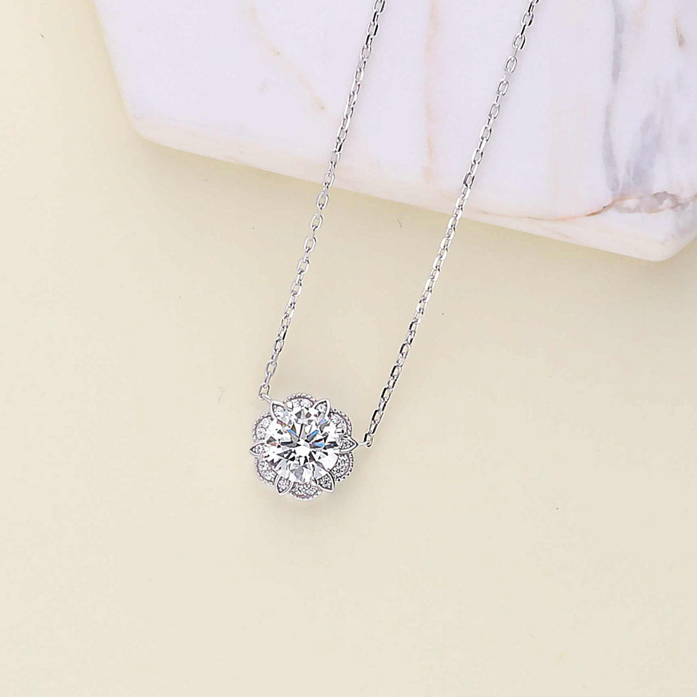 Flatlay view of Flower Halo CZ Pendant Necklace in Sterling Silver