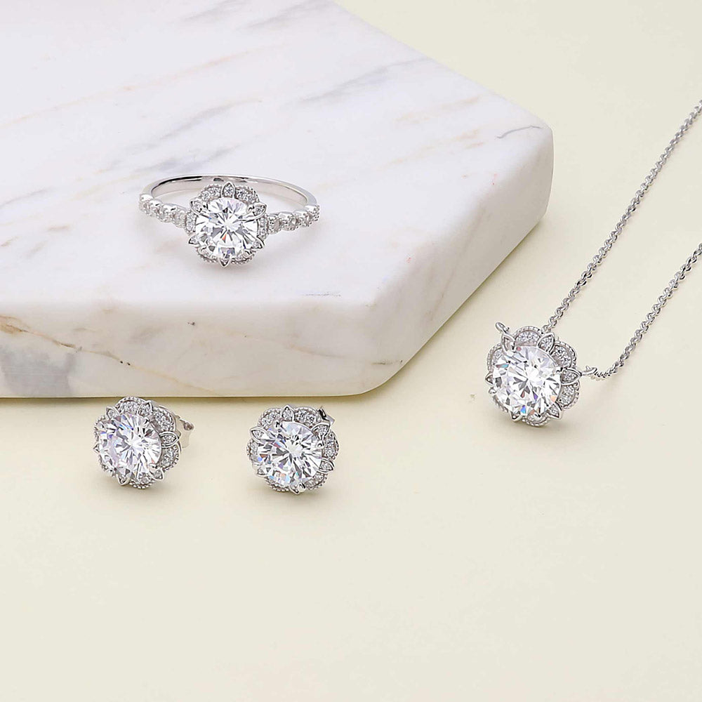 Flatlay view of Flower Halo CZ Necklace and Earrings Set in Sterling Silver