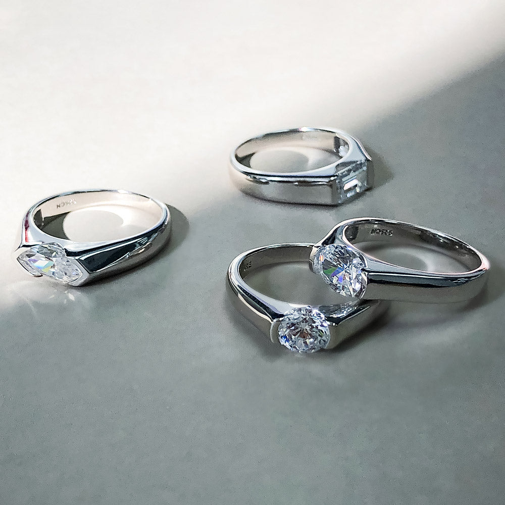 Flatlay view of East-West Solitaire Half Bezel Set CZ Ring in Sterling Silver