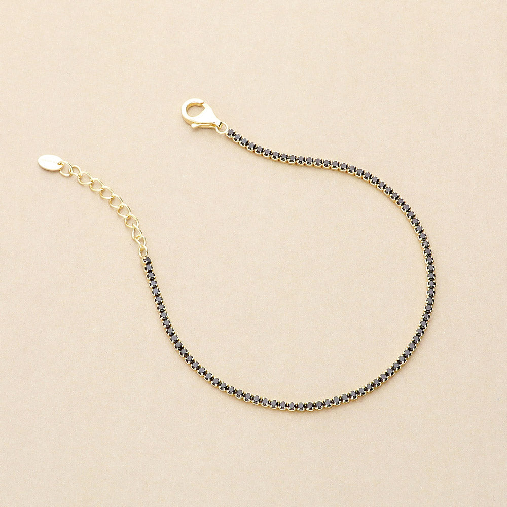 Flatlay view of CZ Tennis Bracelet in Sterling Silver, Yellow Gold Flashed, Black