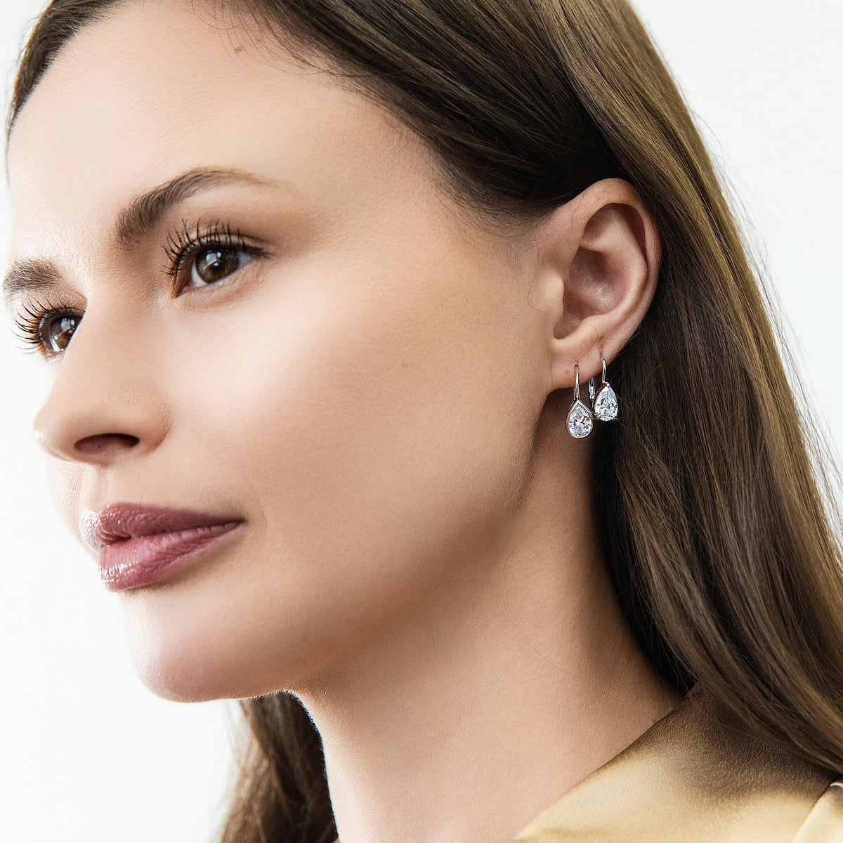 Model wearing Solitaire 2.6ct Pear CZ Leverback Earrings in Sterling Silver, Rhodium Plated