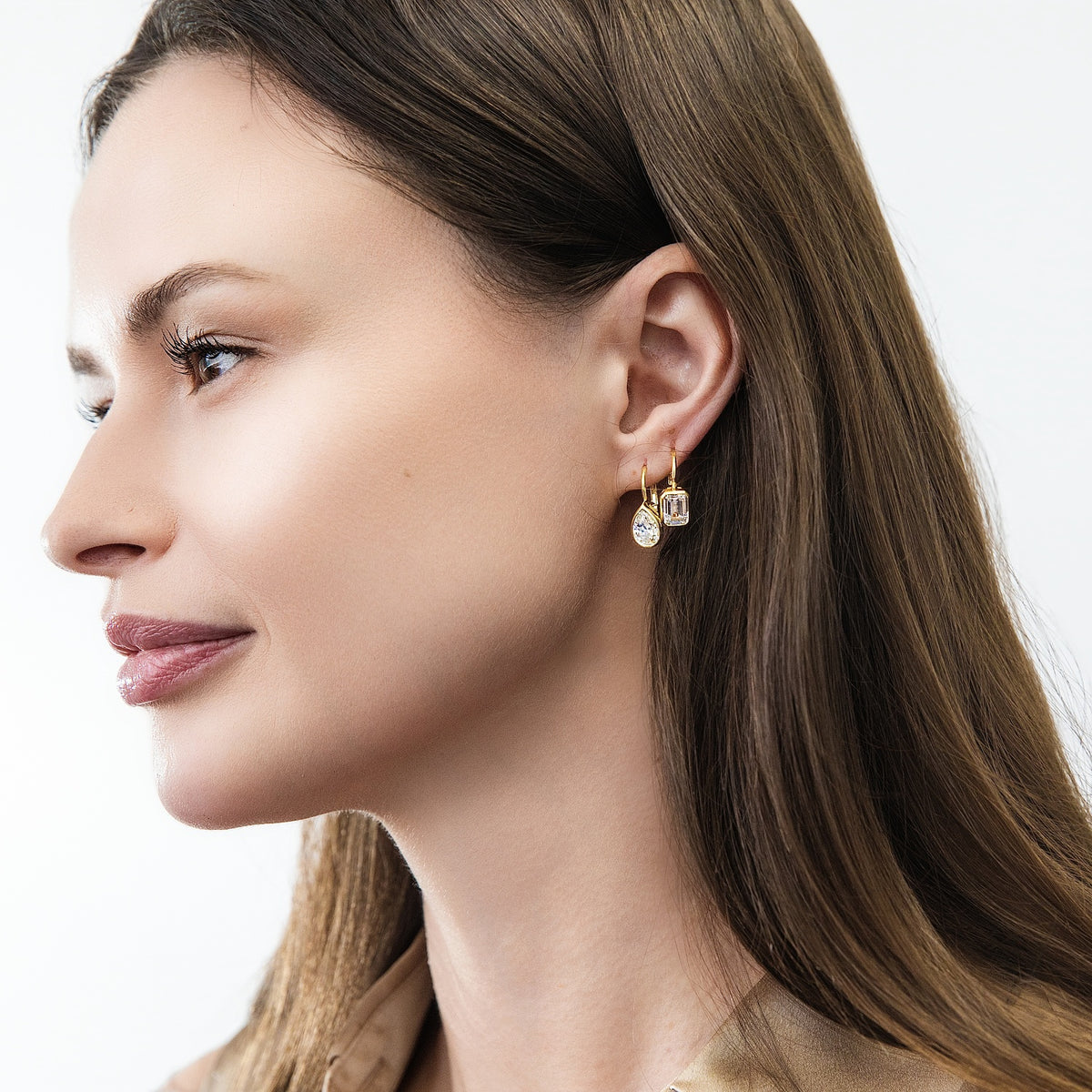 Model wearing Solitaire 2.6ct Pear CZ Leverback Earrings in Sterling Silver, Gold Flashed
