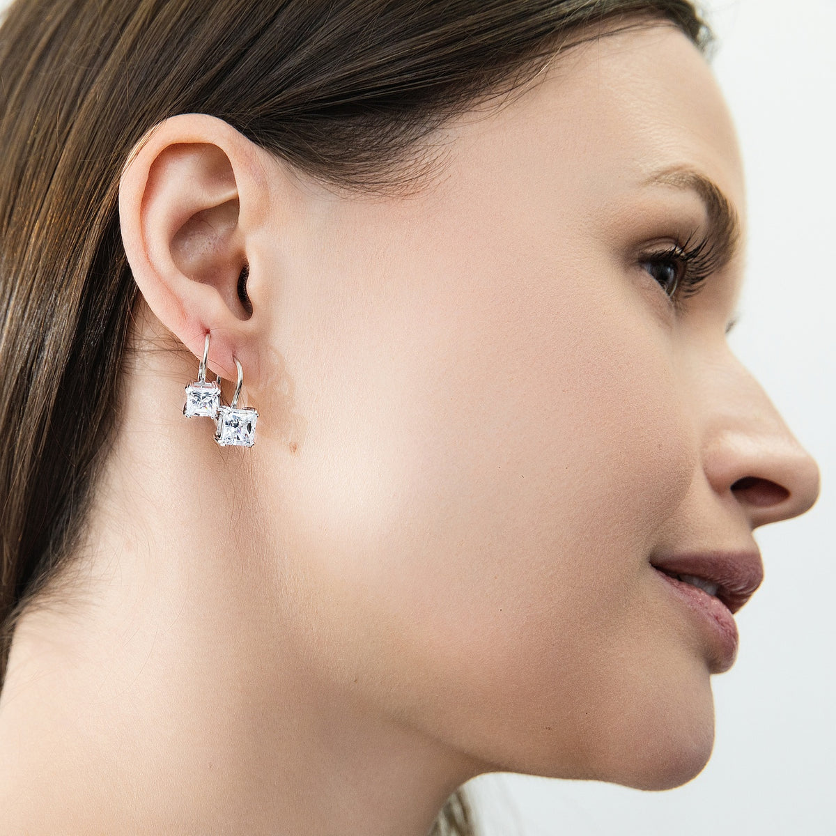 Model wearing Solitaire 4ct Princess CZ Leverback Earrings in Sterling Silver, Rhodium Plated