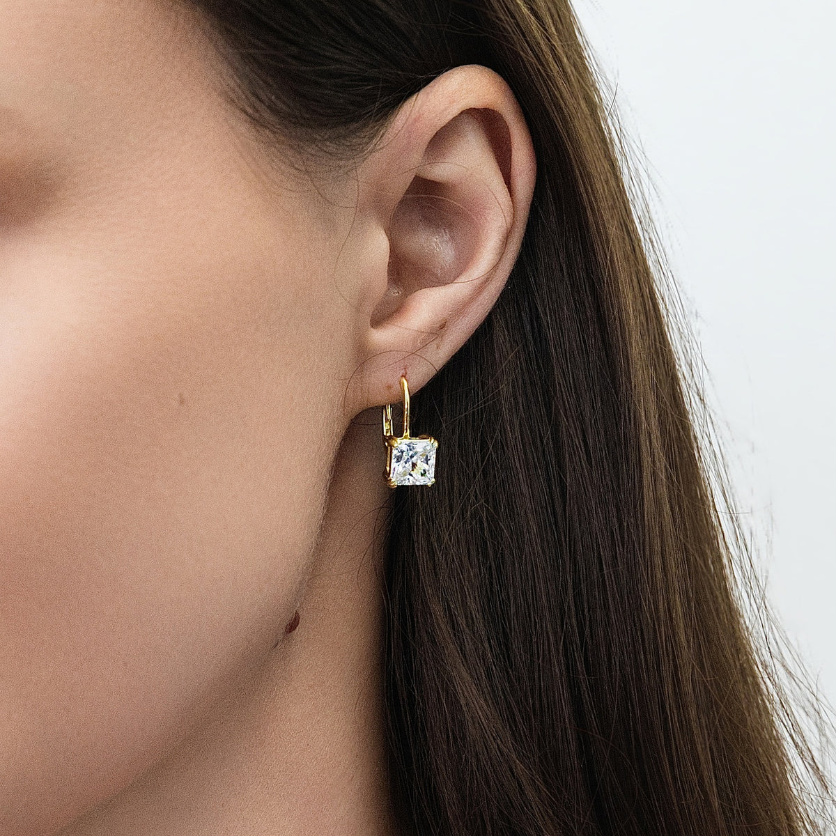 Model wearing Solitaire 4ct Princess CZ Leverback Earrings in Sterling Silver, Gold Flashed