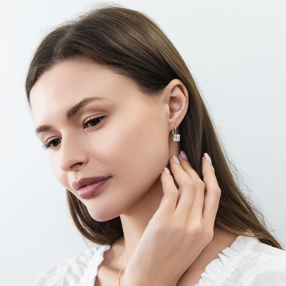 Model wearing Solitaire 4ct Princess CZ Leverback Earrings in Sterling Silver, Gold Flashed