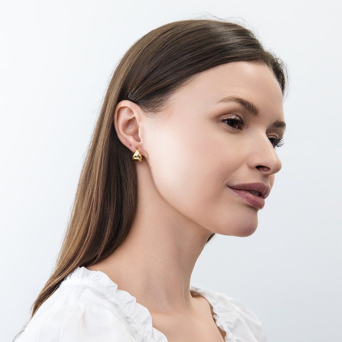 Model wearing Dome Mini Huggie Earrings 0.5 inch, Gold Flashed