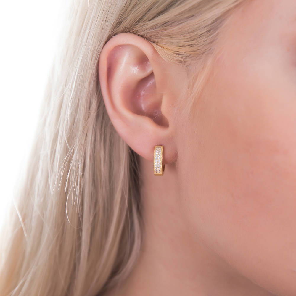 Model wearing Milgrain CZ Small Huggie Earrings in Sterling Silver 0.6 inch, Yellow Gold Flashed