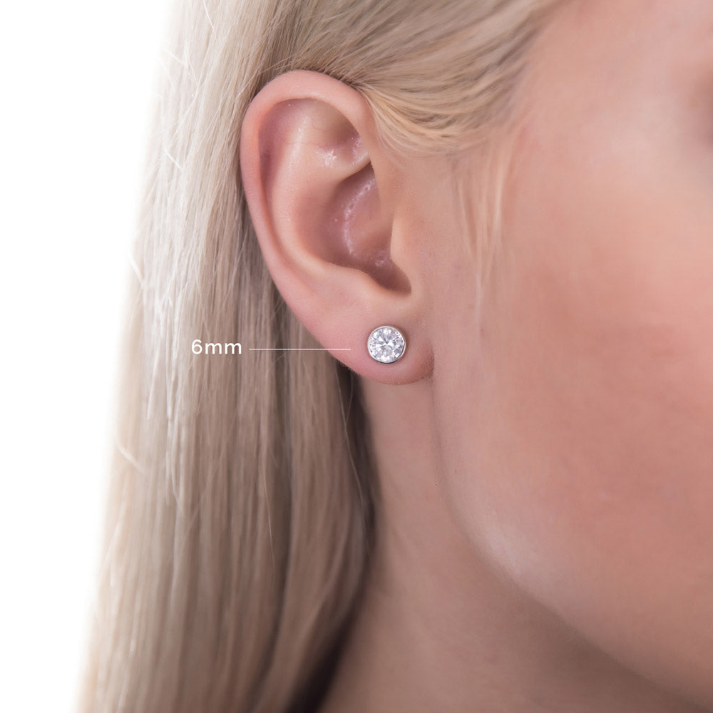 Model wearing Solitaire Bezel CZ Stud Earrings in Gold Flashed Sterling Silver, Rhodium Plated, Clear / 6mm