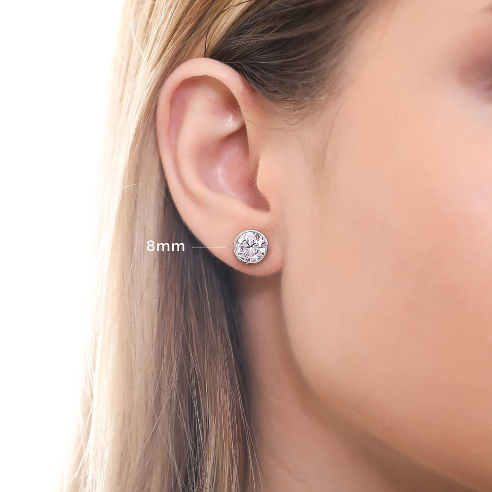 Model wearing Solitaire Bezel CZ Stud Earrings in Gold Flashed Sterling Silver, Rhodium Plated, Clear / 8mm