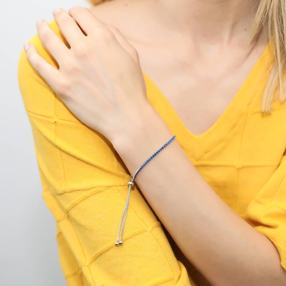 Model wearing CZ Tennis Bracelet Gold Flashed, Blue Color