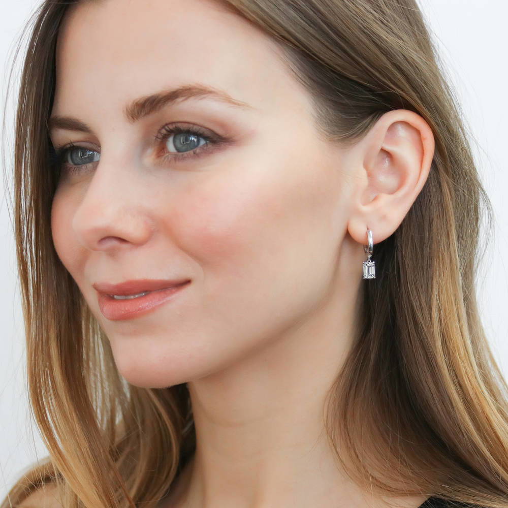 Model wearing Solitaire CZ Cartilage Huggie Earrings in Sterling Silver 0.5 inch, Emerald Cut
