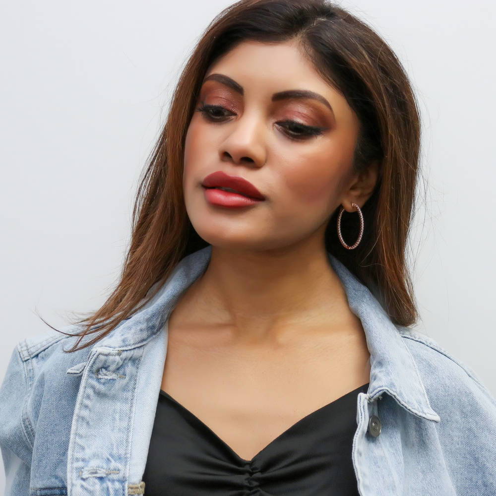 Model wearing Oval CZ Inside-Out Hoop Earrings in Sterling Silver 1.4 inch, Rose Gold Flashed