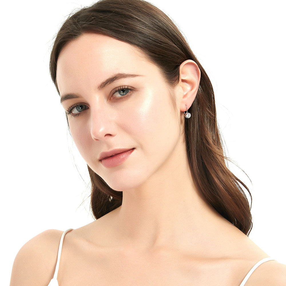 Model wearing Solitaire 1.2ct Bezel CZ Leverback Earrings in Sterling Silver, Yellow Gold Flashed