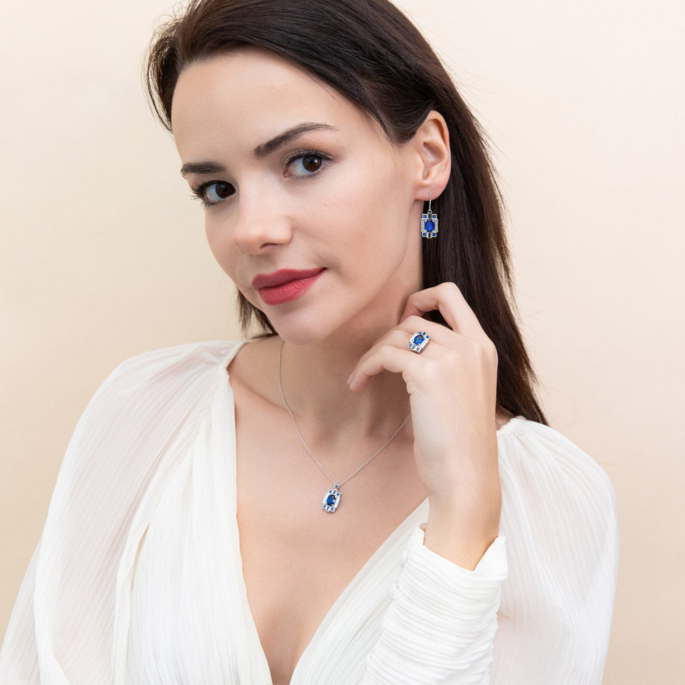 Model wearing Art Deco Simulated Blue Sapphire CZ Dangle Earrings in Sterling Silver