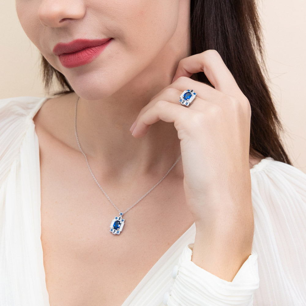 Model wearing Art Deco Simulated Blue Sapphire CZ Pendant Necklace in Sterling Silver