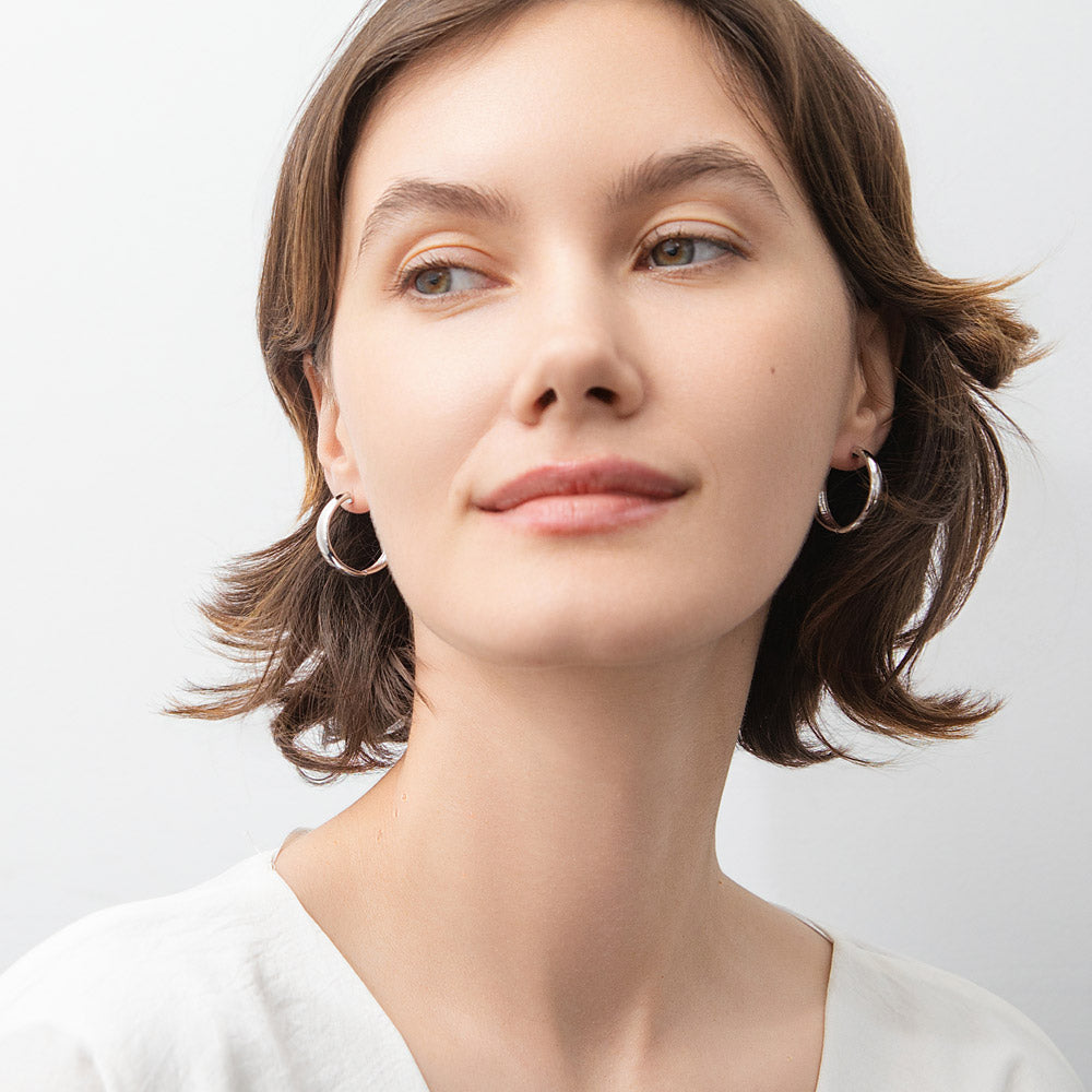 Model wearing Dome Small Hoop Earrings in Sterling Silver 0.8-1 inch, 2 Pairs, Rhodium Plated