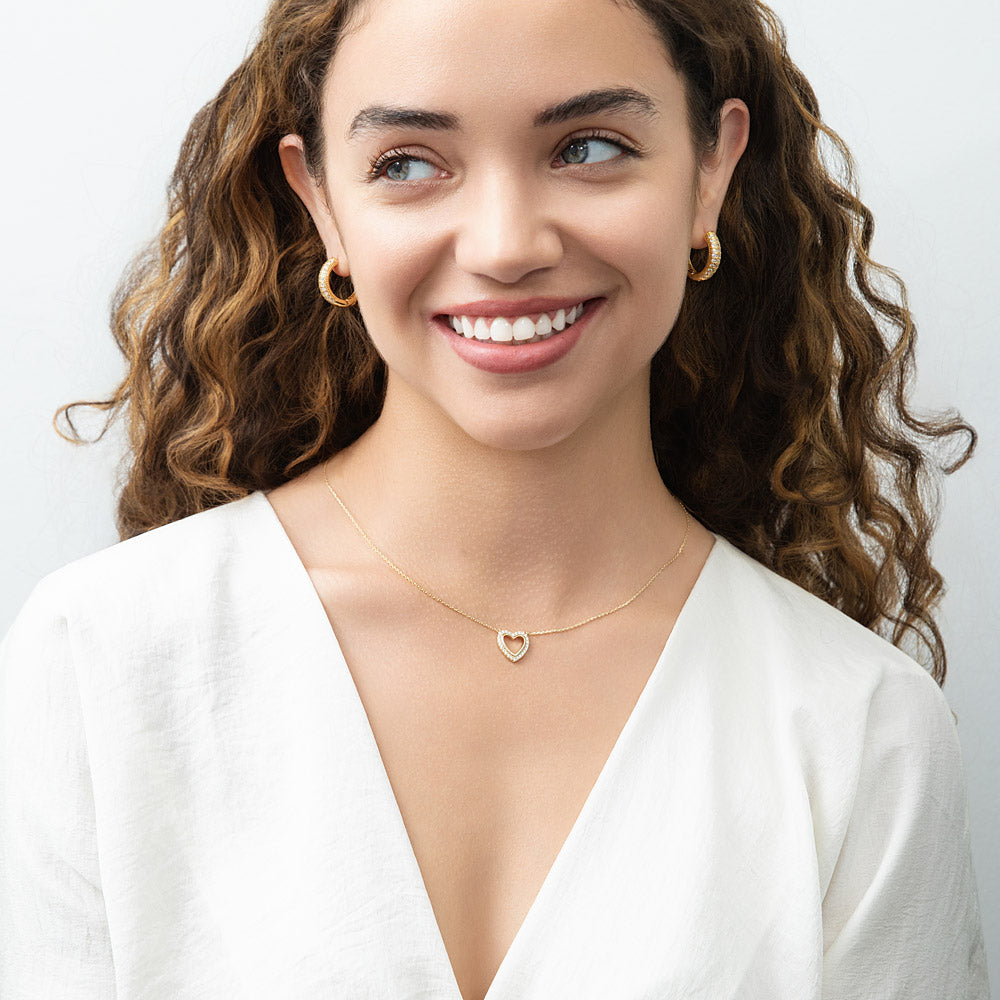 Model wearing Open Heart CZ Necklace in Sterling Silver, Yellow Gold Flashed