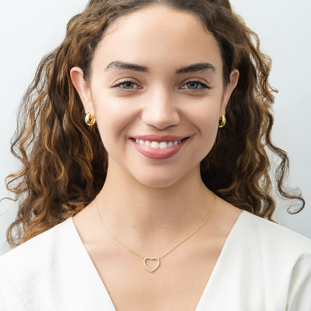 Model wearing Open Heart CZ Necklace in Sterling Silver, Yellow Gold Flashed
