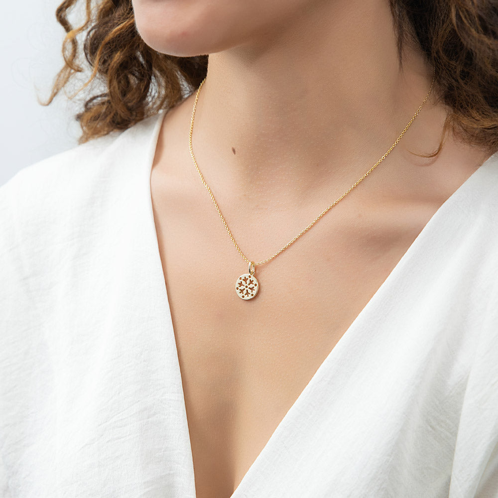 Model wearing Snowflake Coin Necklace in Sterling Silver, Yellow Gold Flashed