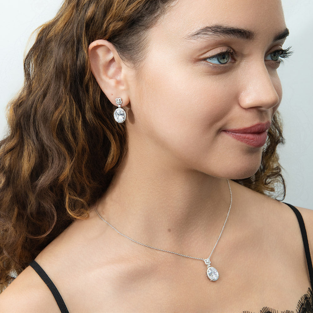 Model wearing Halo Clover Oval CZ Earrings in Sterling Silver, Clear Color
