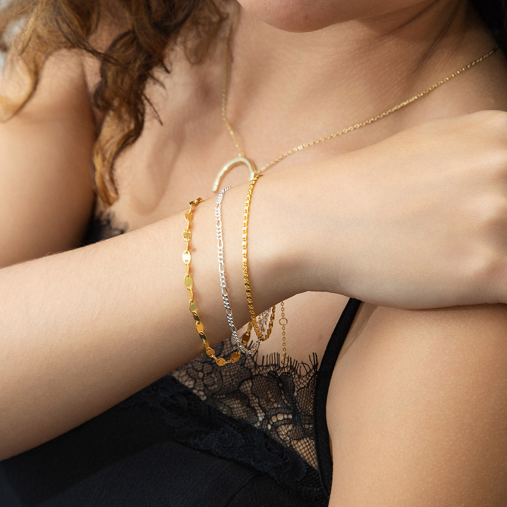 Model wearing Figaro Chain Bracelet in Sterling Silver, Yellow Gold Flashed