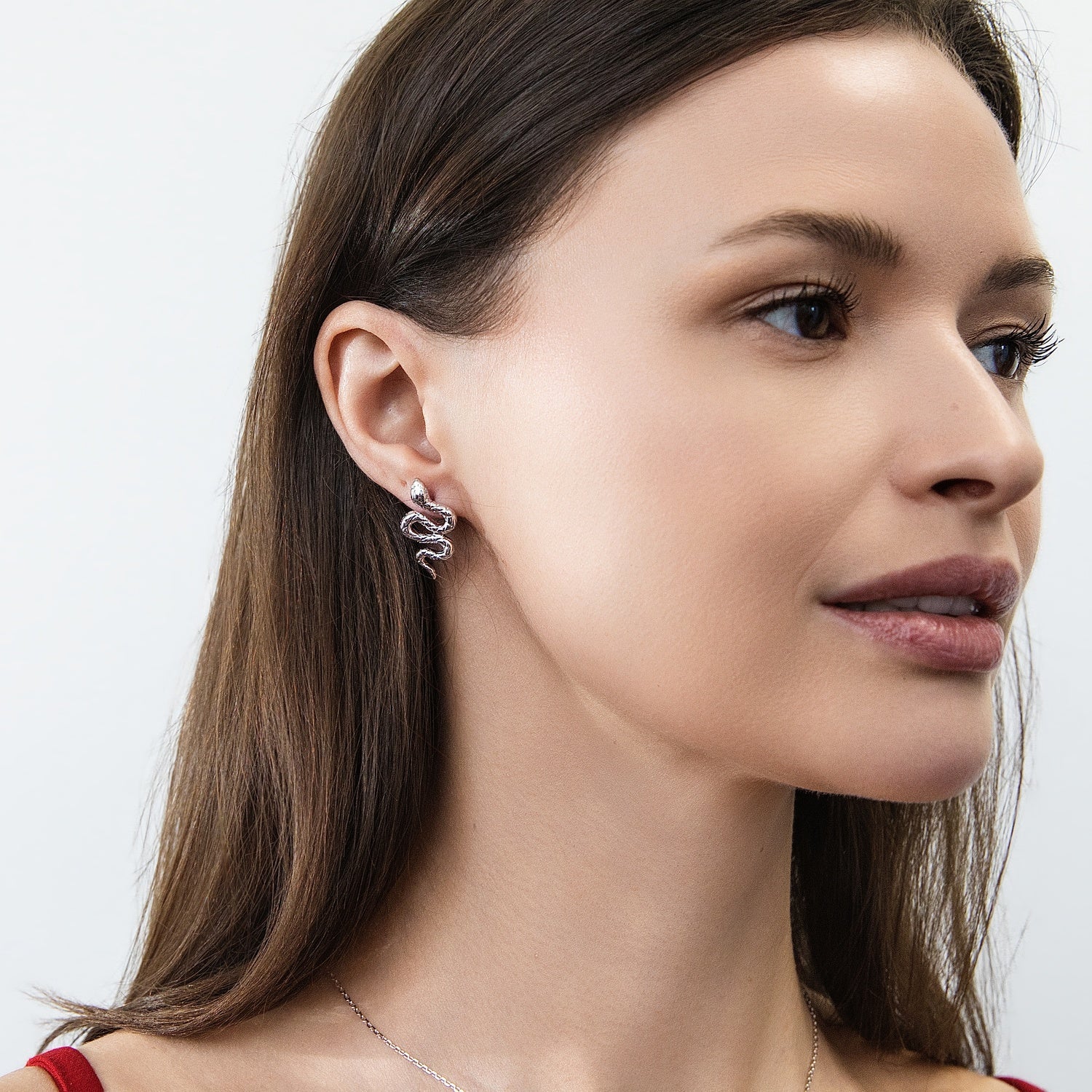 Model wearing Snake CZ Stud Earrings in Sterling Silver, Rhodium Plated