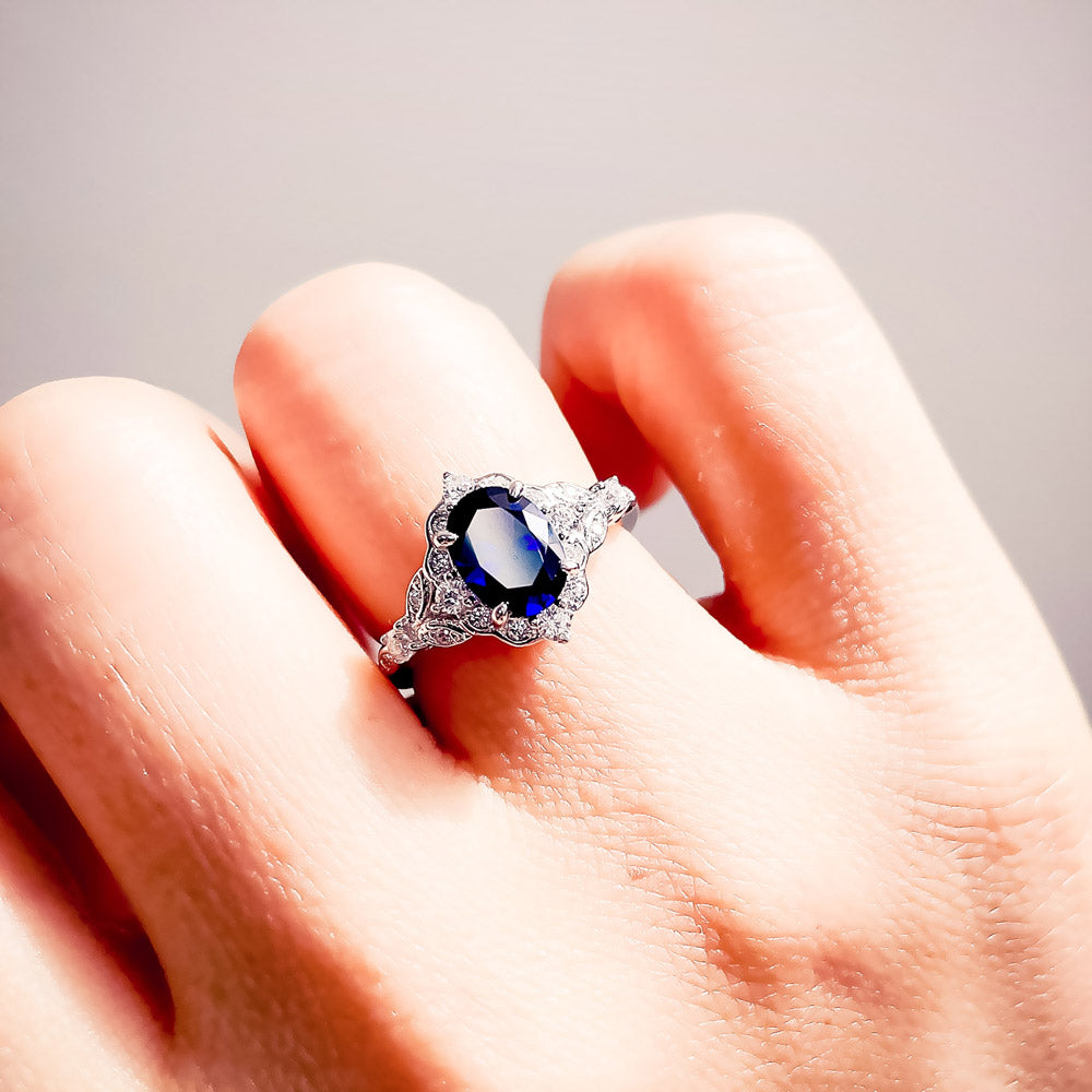 Model wearing Halo Art Deco Simulated Blue Sapphire Oval CZ Ring in Sterling Silver