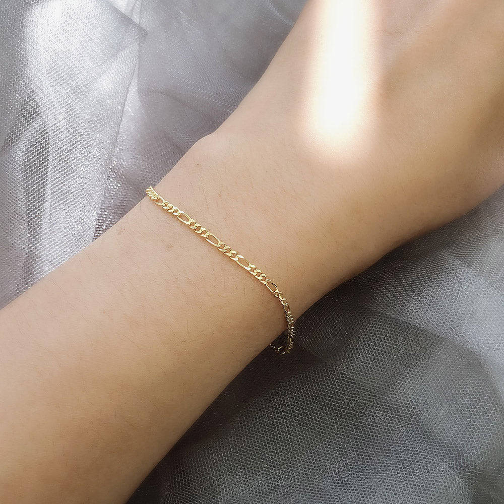 Model wearing Figaro Chain Bracelet in Sterling Silver, Yellow Gold Flashed