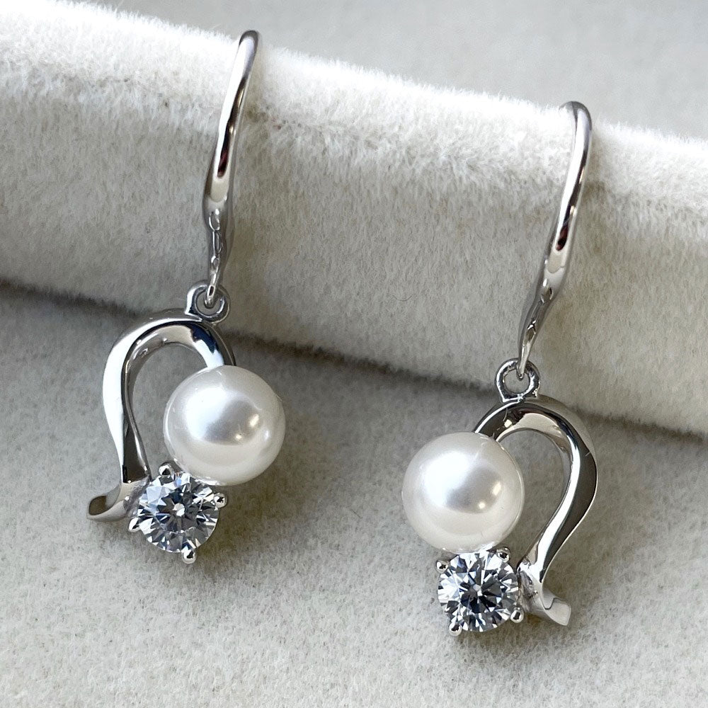 Flatlay view of Ball Bead Imitation Pearl Fish Hook Dangle Earrings in Sterling Silver