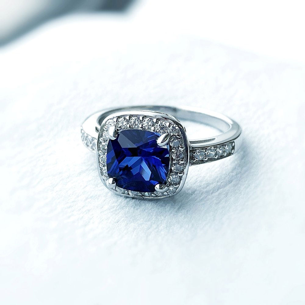 Flatlay view of Halo Simulated Blue Sapphire Cushion CZ Ring in Sterling Silver