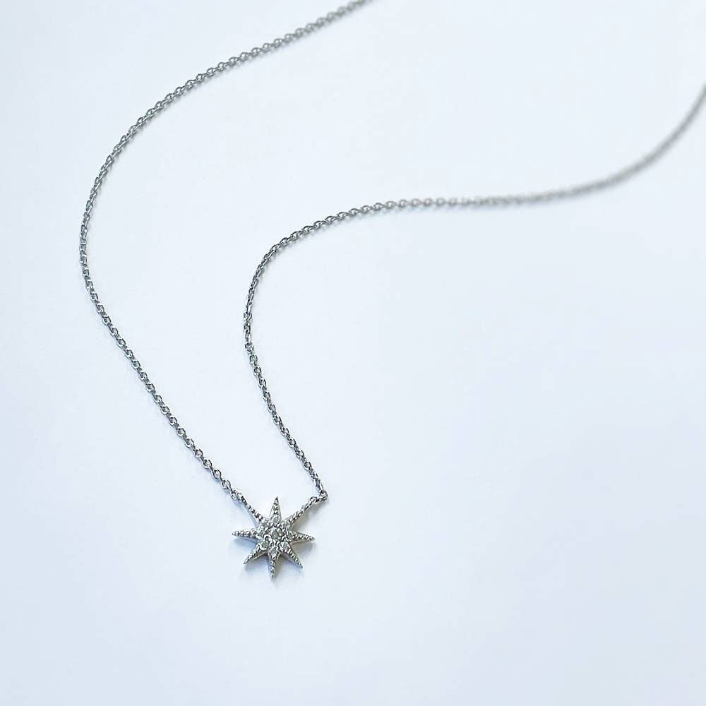 Flatlay view of Starburst CZ Pendant Necklace in Sterling Silver