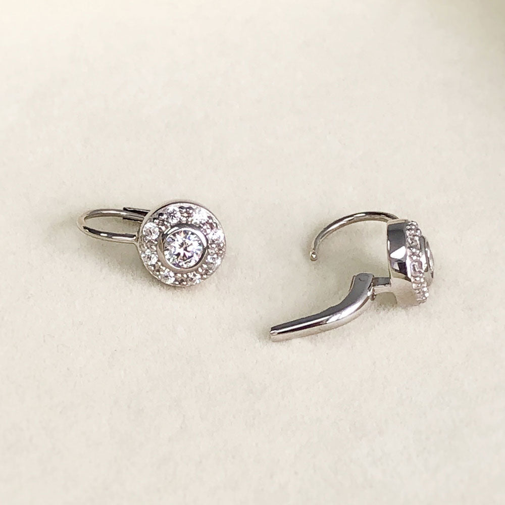 Flatlay view of Halo Round CZ Leverback Dangle Earrings in Sterling Silver