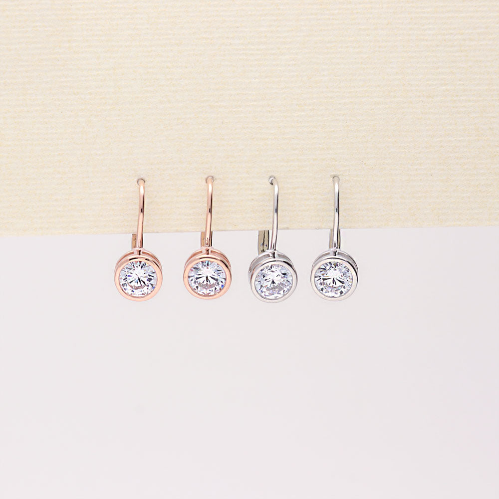 Flatlay view of Solitaire 1.2ct Bezel Set Round CZ Dangle Earrings in Sterling Silver