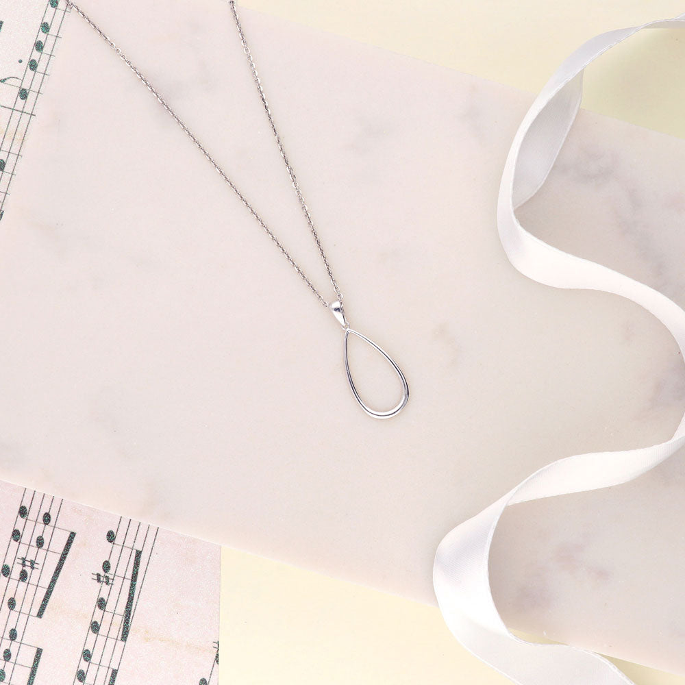 Flatlay view of Teardrop Necklace and Earrings Set in Sterling Silver