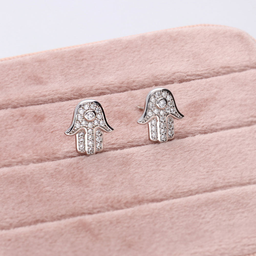 Flatlay view of Hamsa Hand CZ Stud Earrings in Sterling Silver