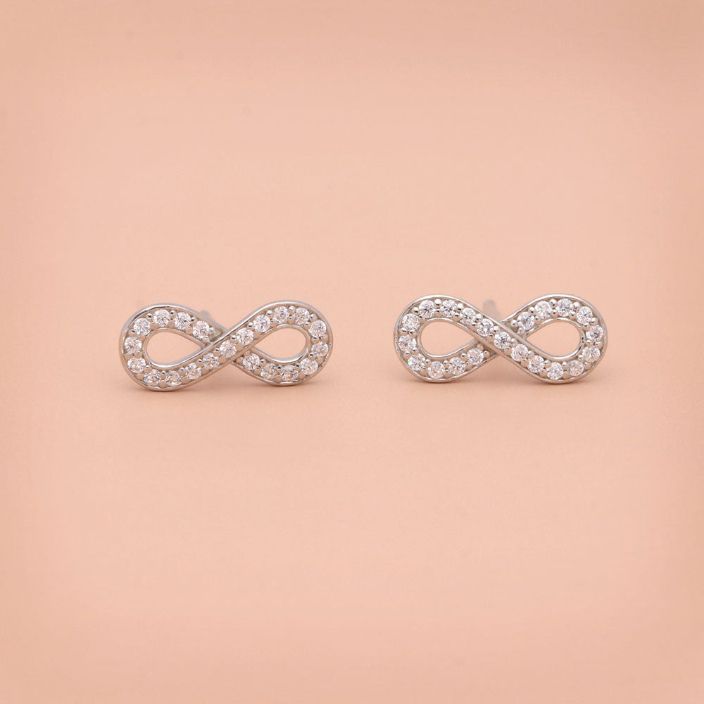 Flatlay view of Infinity CZ Stud Earrings in Sterling Silver