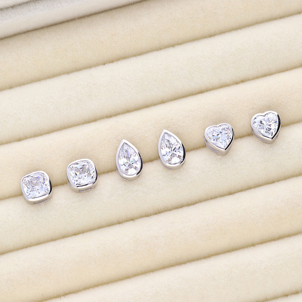 Flatlay view of Solitaire Bezel Set Pear CZ Stud Earrings in Sterling Silver 1.6ct