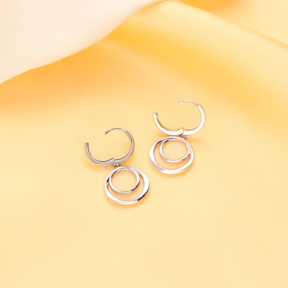 Flatlay view of Open Circle Dangle Earrings in Sterling Silver