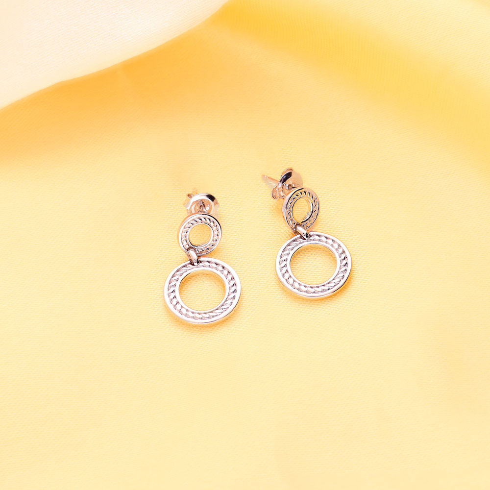 Flatlay view of Open Circle Cable Dangle Earrings in Sterling Silver