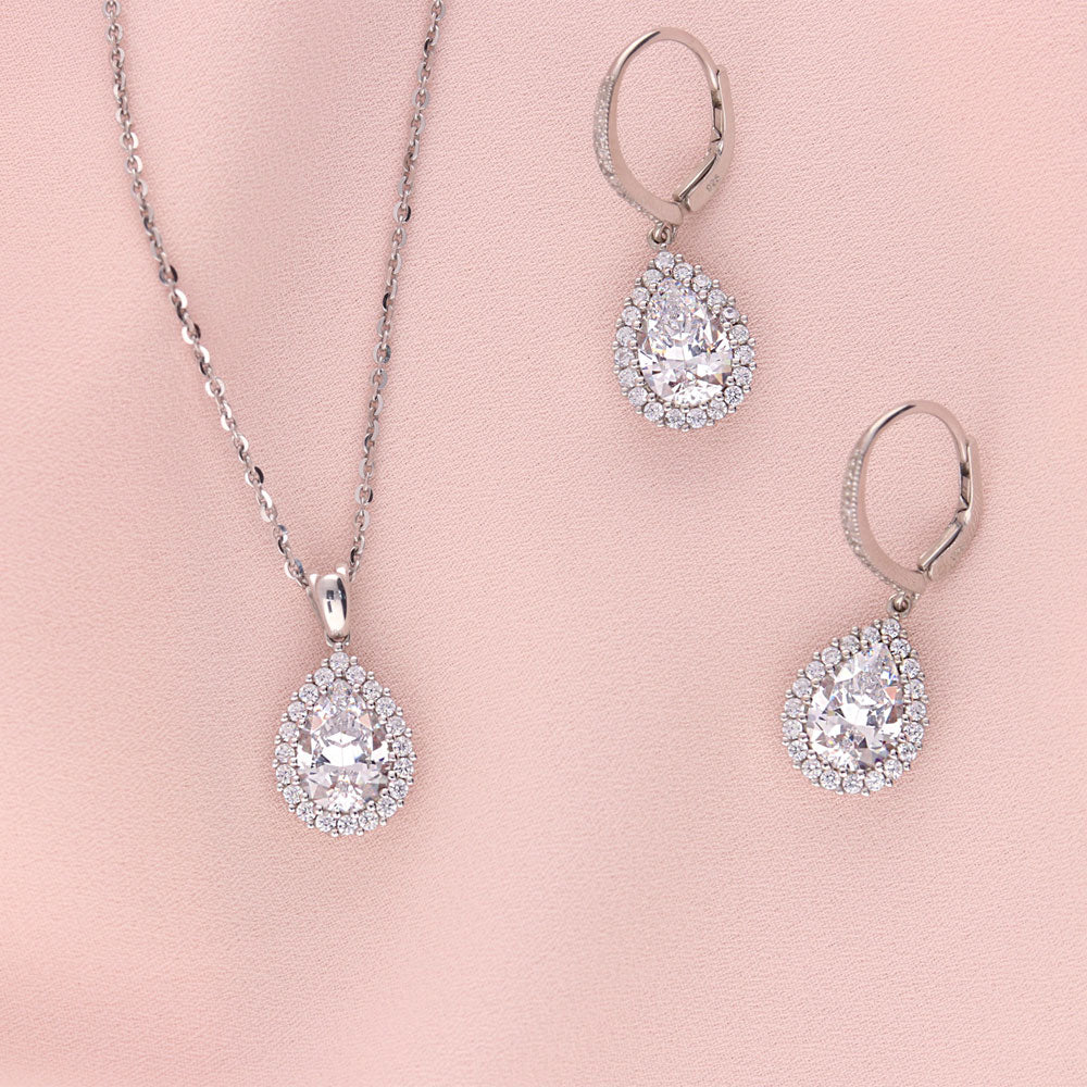 Flatlay view of Halo Pear CZ Necklace and Earrings Set in Sterling Silver