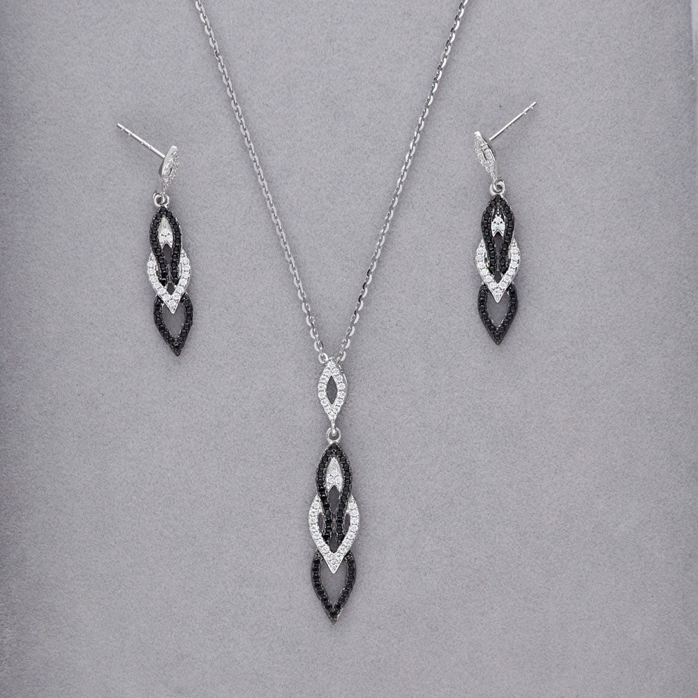 Flatlay view of Black and White CZ Dangle Earrings in Sterling Silver