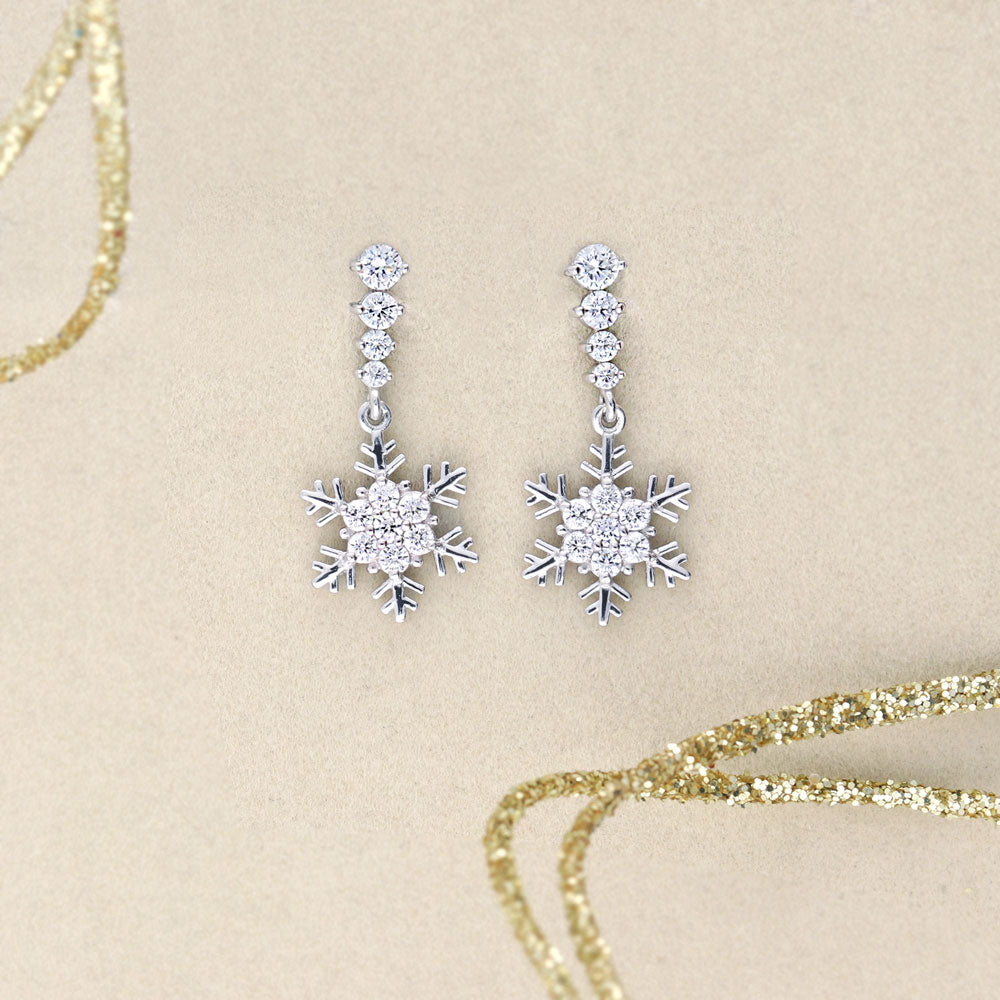 Flatlay view of Snowflake CZ Dangle Earrings in Sterling Silver